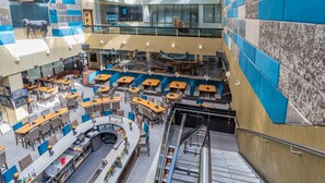 A multi-level indoor space with seating areas, a bar, and a staircase. - Sandman Signature Edmonton Downtown Hotel (Edmonton)