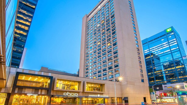 A tall hotel with a modern glass facade, a ground-level shop, and a visible sign for 'Sandman Signature'. - Sandman Signature Edmonton Downtown Hotel (Edmonton)