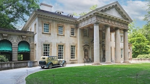 A historic building with a classical architectural style, featuring a central entrance with columns and a symmetrical facade.
