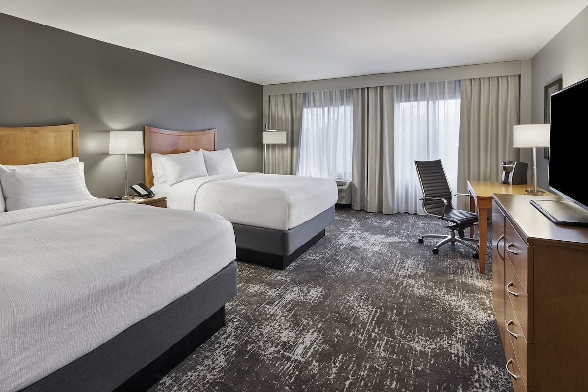 Hypo-allergenic bedding, desk, laptop workspace, blackout drapes