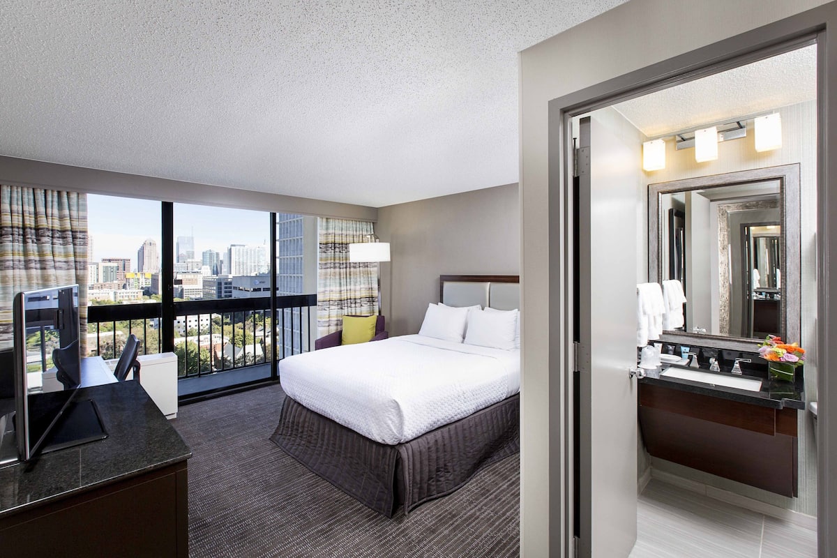 Premium bedding, desk, laptop workspace, blackout drapes