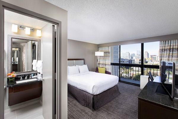 Premium bedding, desk, laptop workspace, blackout drapes