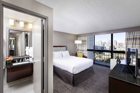 Premium bedding, desk, laptop workspace, blackout drapes