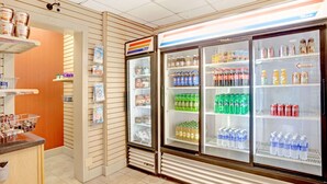 A convenience store with refrigerated beverage cases and a variety of snacks and drinks. - Ramada by Wyndham West Memphis (West Memphis)