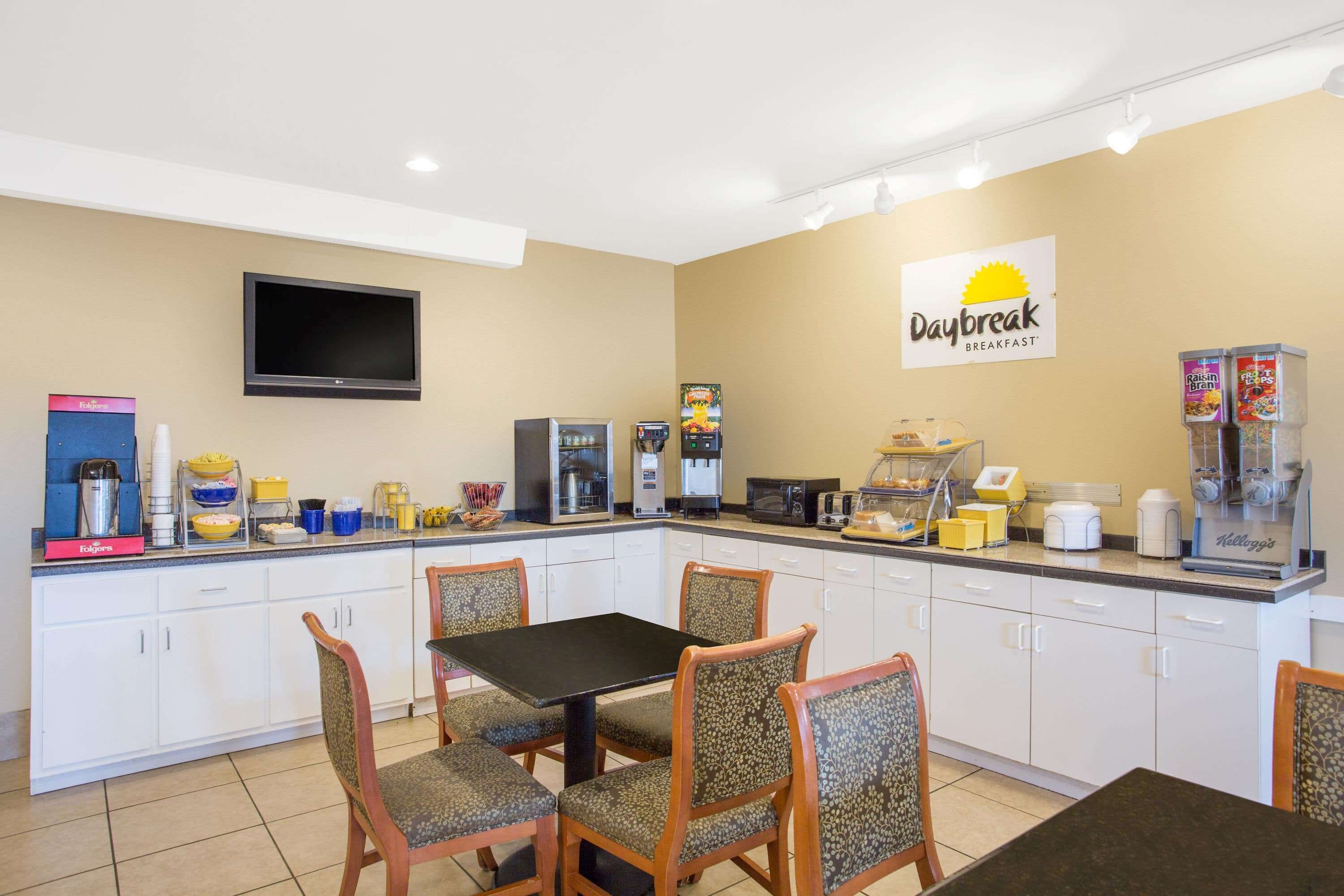 A breakfast area with a table, chairs, and a coffee station.