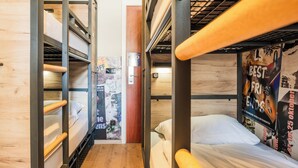 A bunk bed room with wooden walls and a poster on the wall. - a&o Antwerpen Centraal (Antwerp)