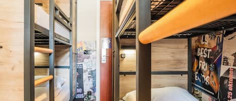 A bunk bed room with wooden walls and a poster on the wall.