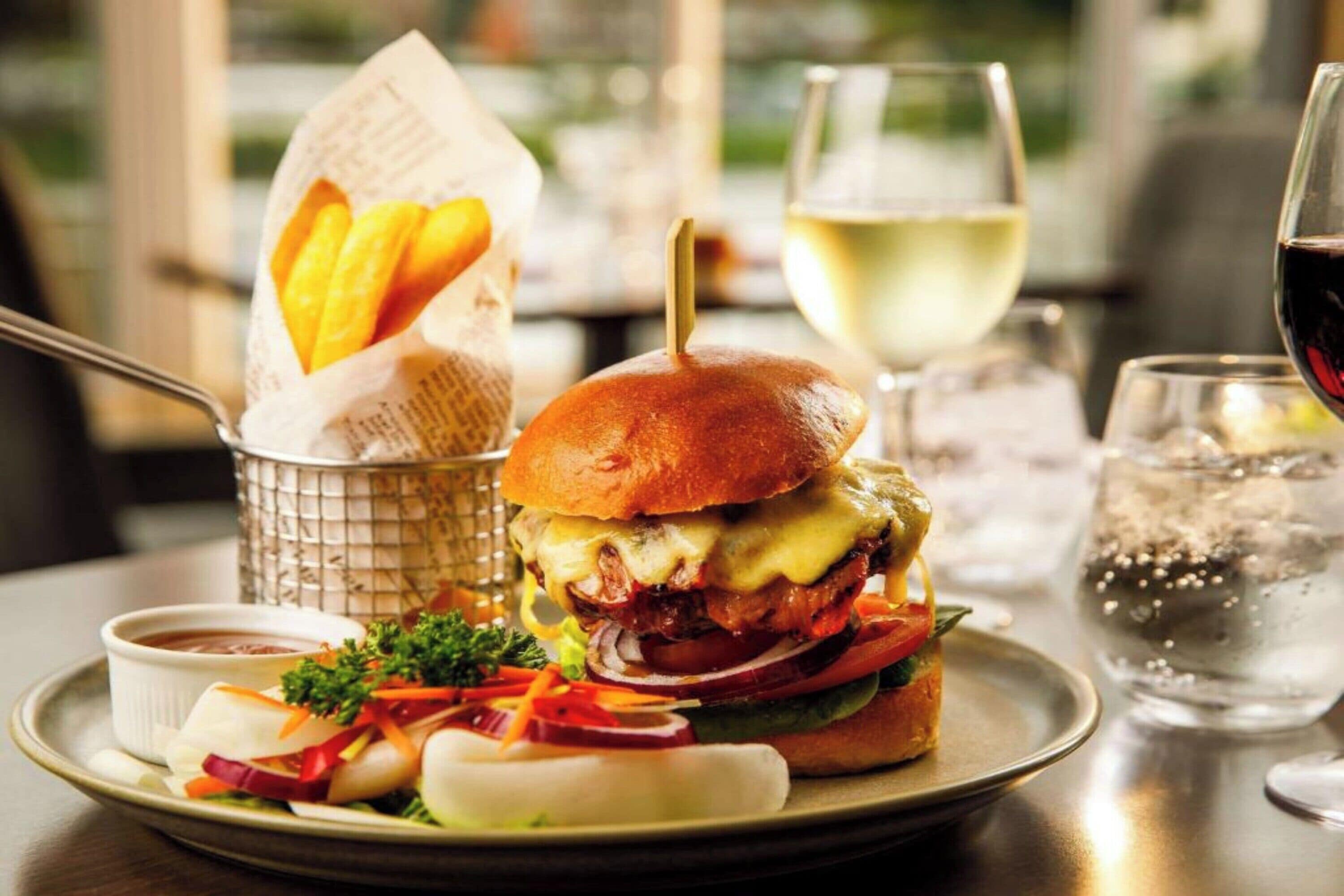 A meal with a burger, fries, and a drink.