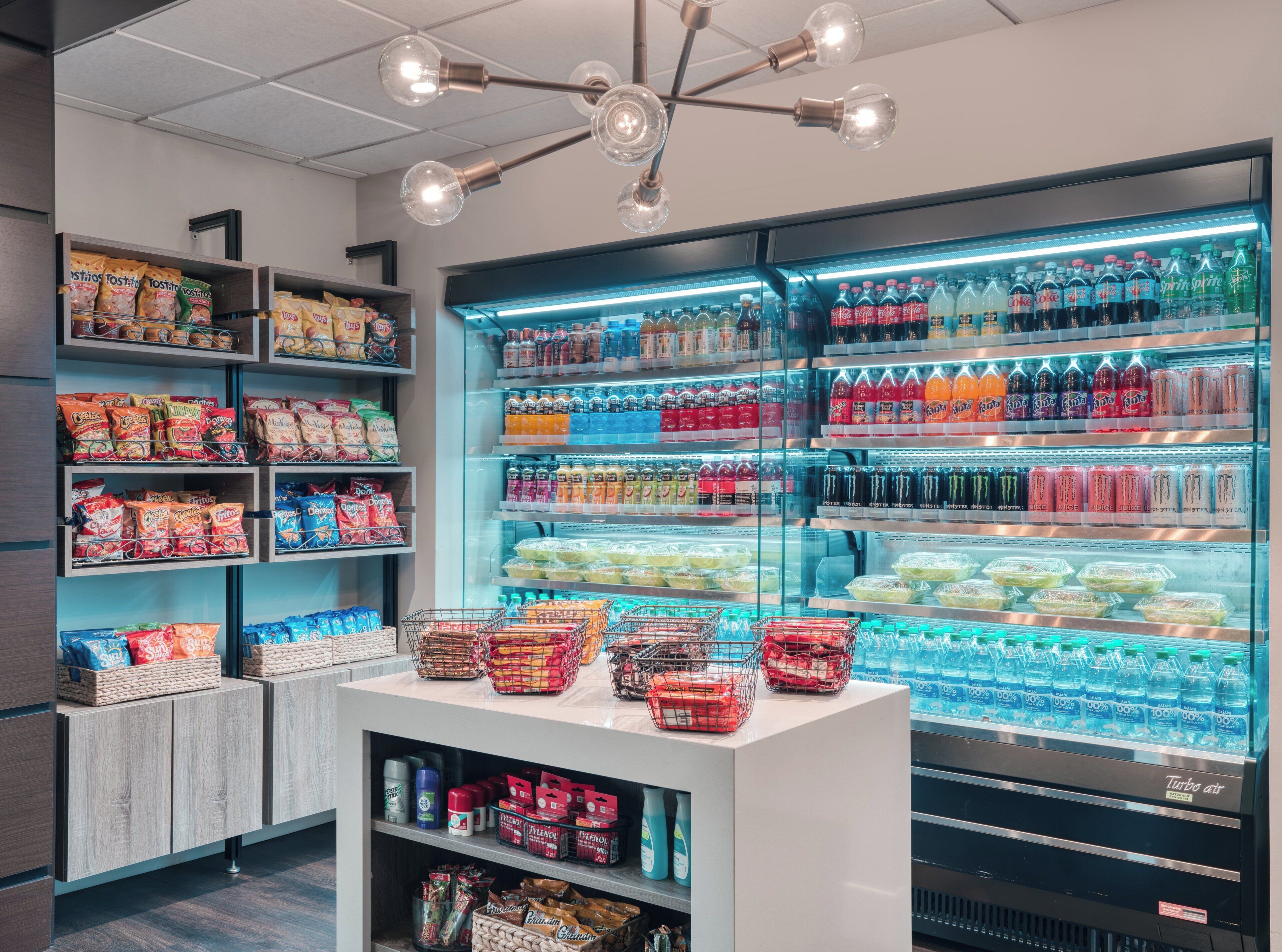 A refrigerated display case with various beverages and snacks.