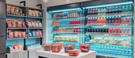 A refrigerated display case with various beverages and snacks.