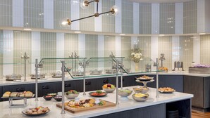A buffet with various food items and a modern interior design. - Crowne Plaza Indianapolis-Dwtn-Union Stn by IHG (Indianapolis)