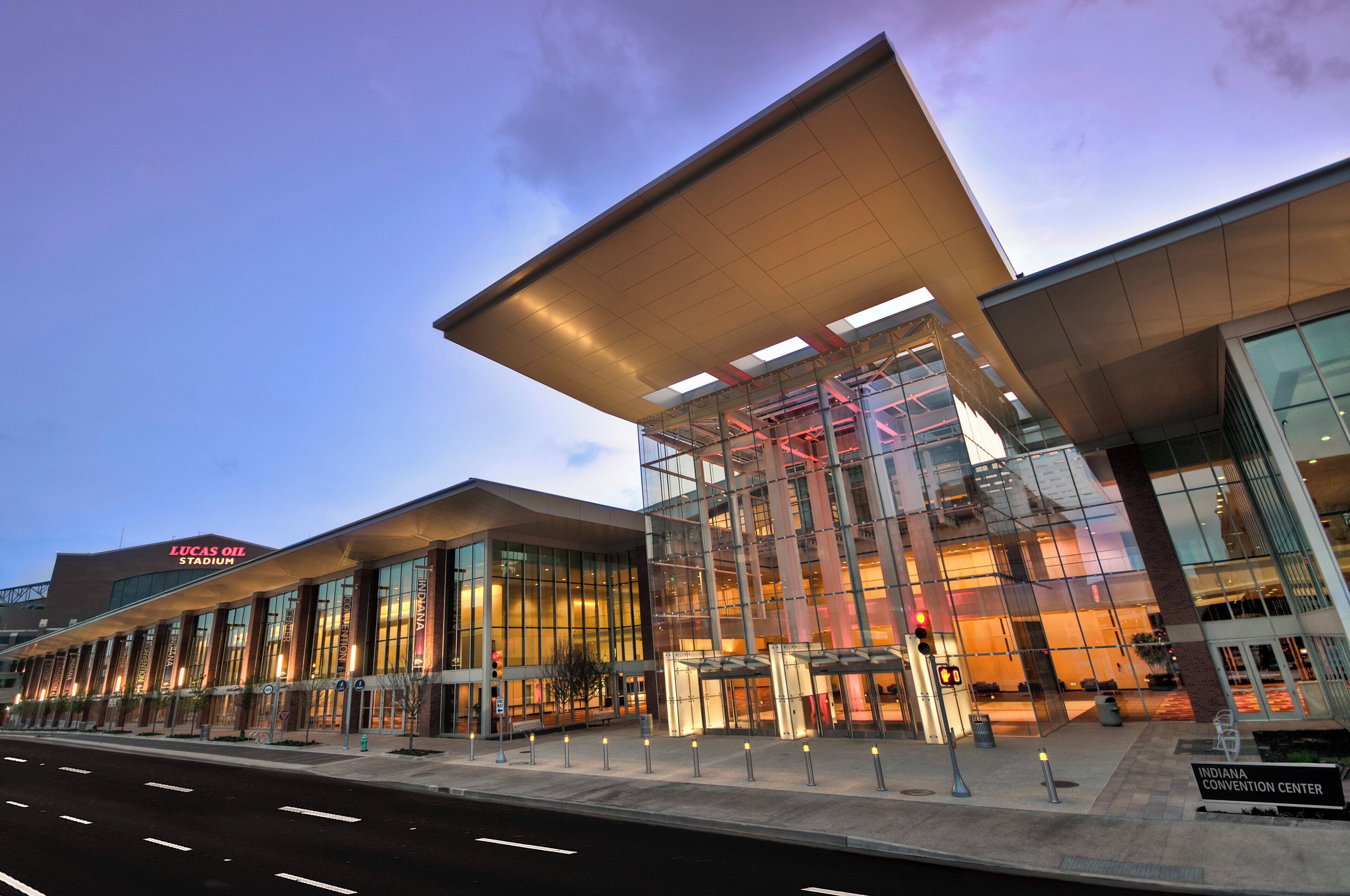 A modern building with a large glass facade and a prominent overhang.