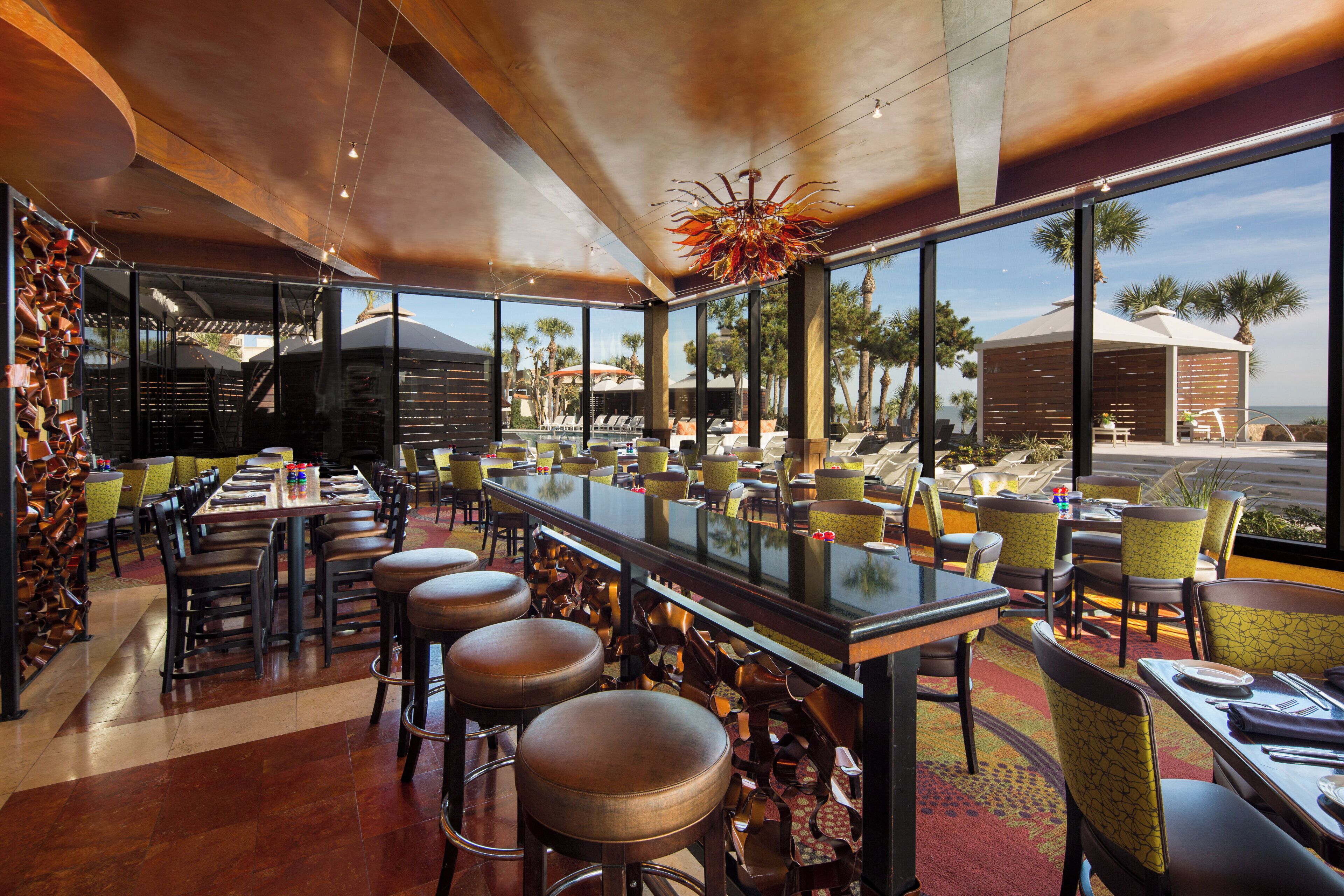 Een restaurant met een bar, terras en uitzicht op het strand.