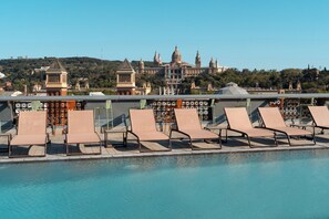 Seasonal outdoor pool, open 9:00 AM to 5:00 PM, pool umbrellas
