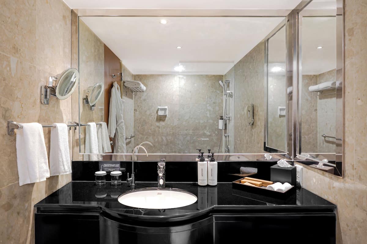 deep-soaking bathtub, rainfall showerhead, designer toiletries