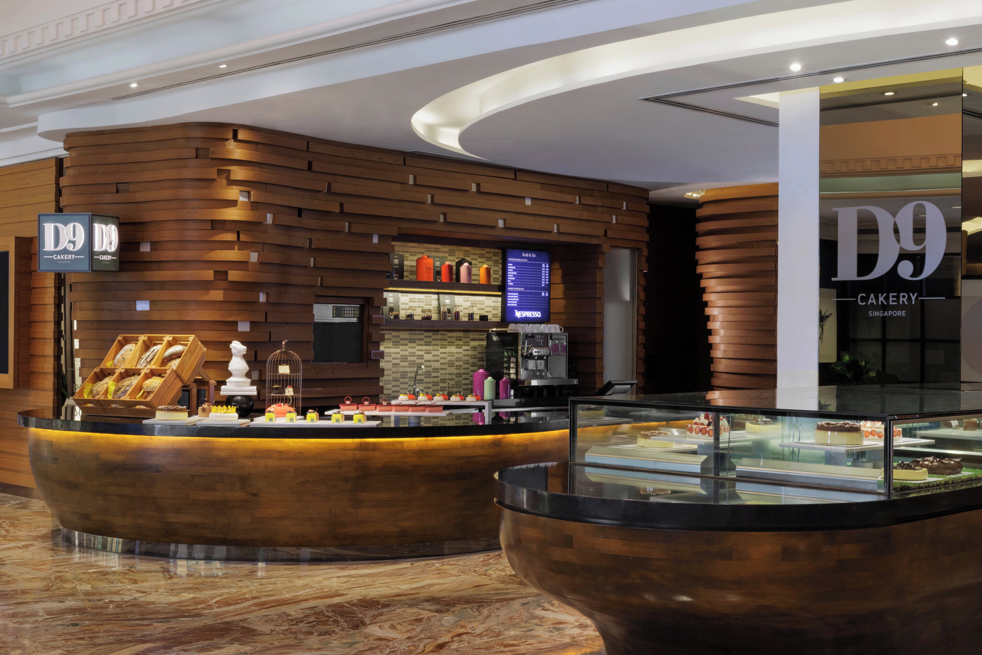 A bakery counter with a display of pastries and a coffee machine.