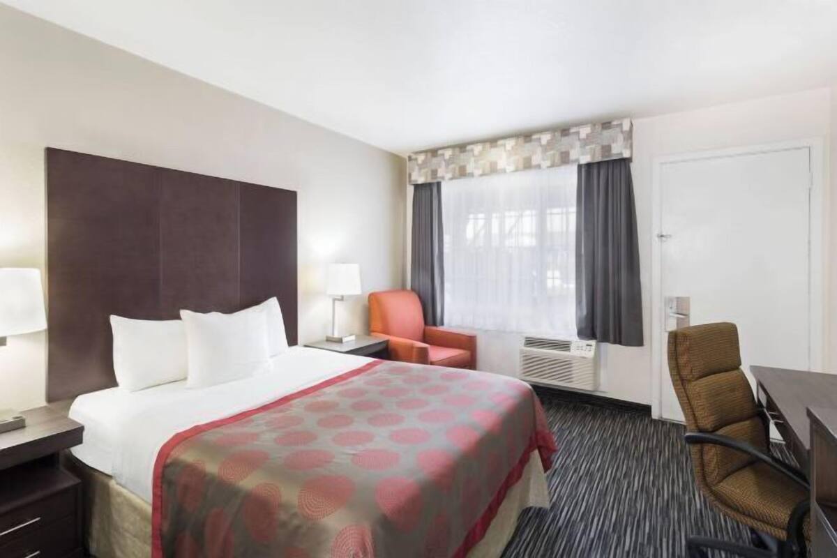 Premium bedding, desk, laptop workspace, blackout curtains