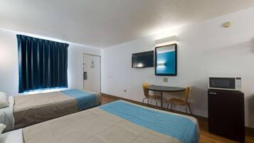 A hotel room with two beds, a desk, a chair, a TV, and a microwave.