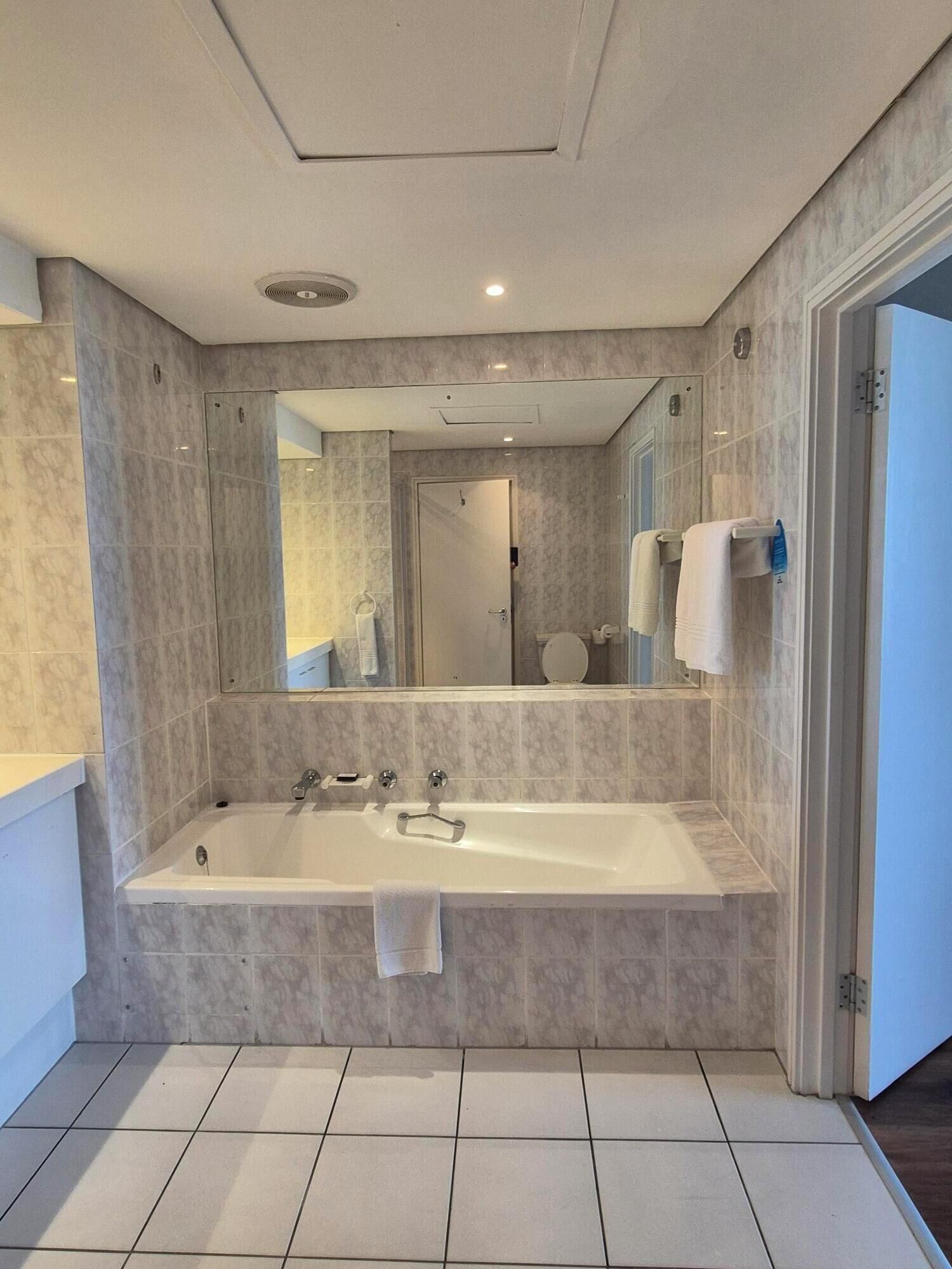 standard studio, 1 queen bed | bathroom | separate bathtub and shower, free toiletries, hair dryer, towels