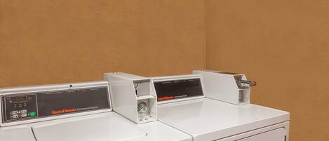 A Speed Queen commercial washer with a control panel and a front-loading door.