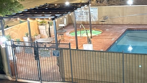 A pool area with a fenced patio, a small pool, and a covered seating area. - Days Inn by Wyndham Yuma (Yuma)