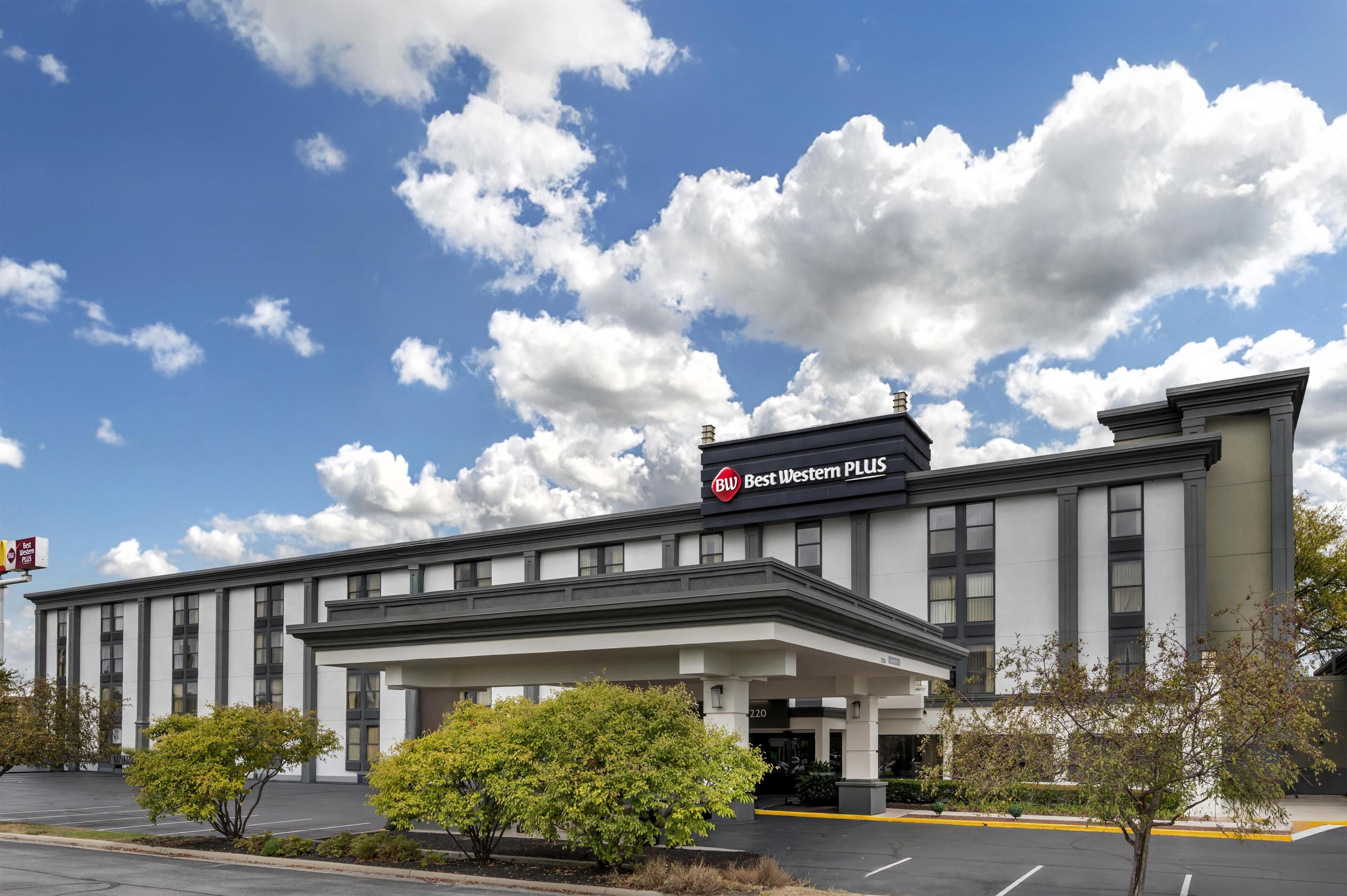 A Best Western Plus hotel with a modern facade, large windows, and a parking lot.