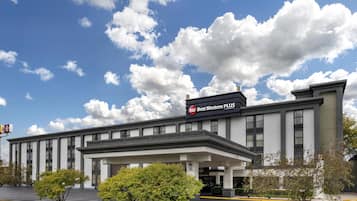A Best Western Plus hotel with a modern facade, large windows, and a parking lot.