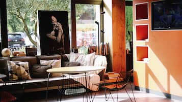 A modern interior with a sofa, a coffee table, and a bookshelf.