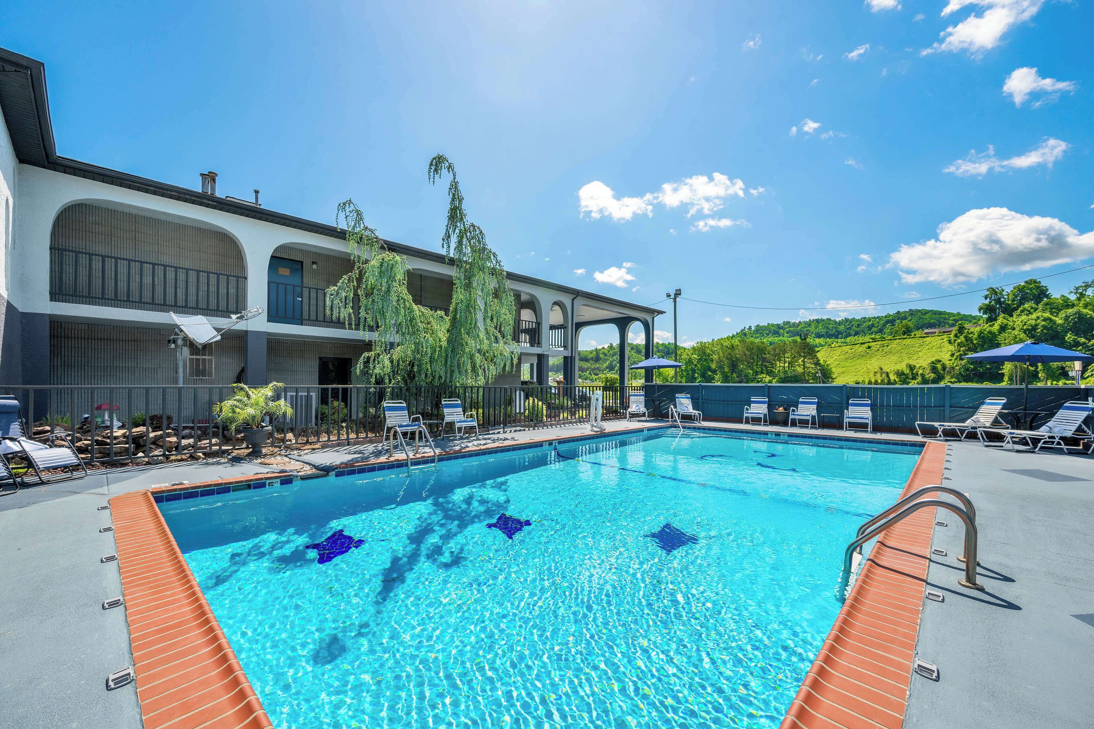 Outdoor pool, open 9:00 AM to 9:00 PM, pool umbrellas, pool loungers