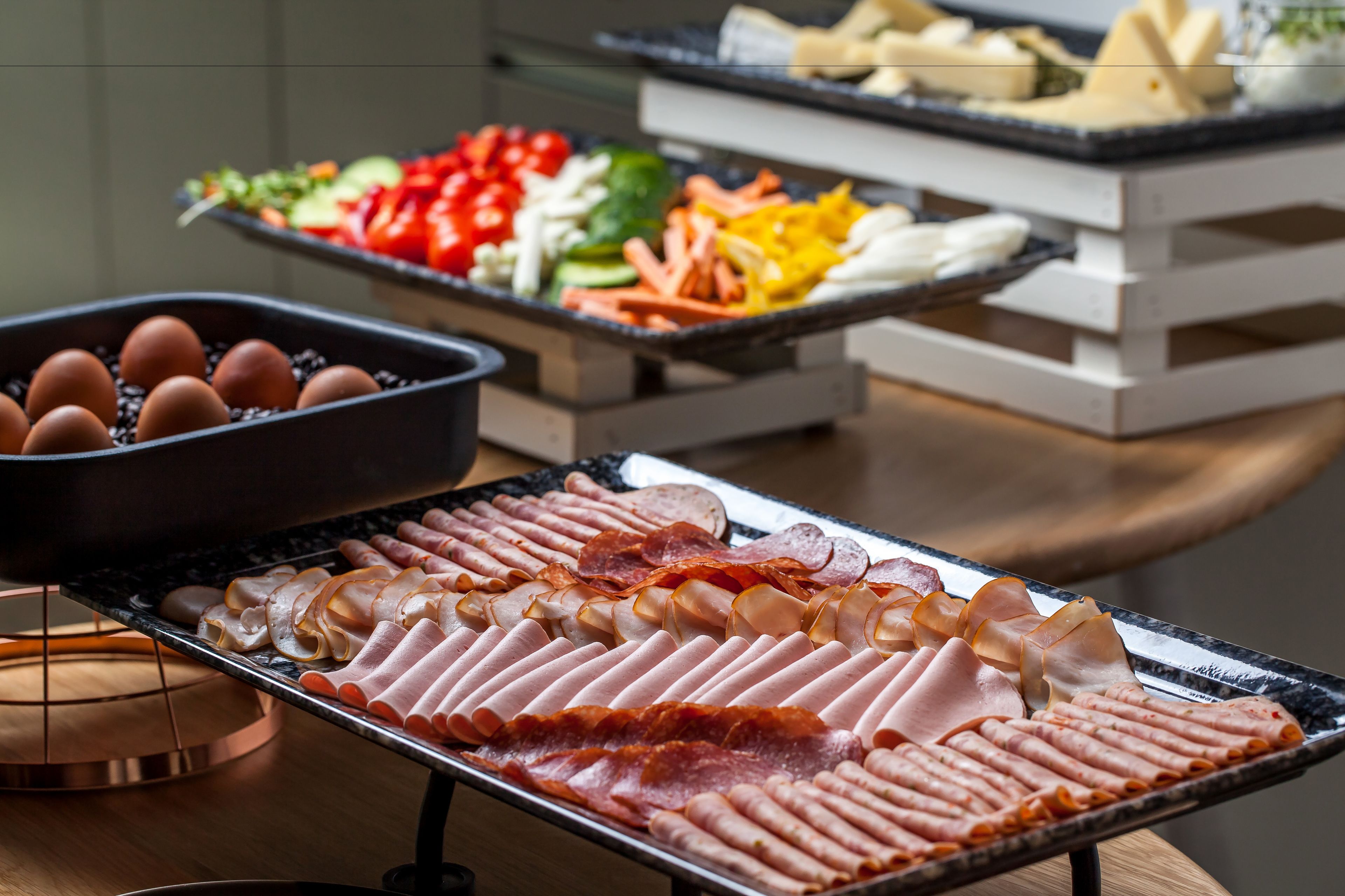 A buffet with various meats and vegetables.