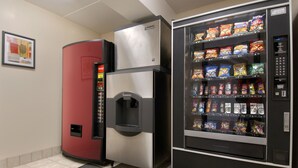 A vending machine with snacks and a refrigerator with a drink dispenser. - Red Roof Inn Pensacola – I-10 at Davis Highway (Pensacola)