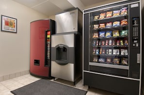 A vending machine with snacks and a refrigerator with a drink dispenser. - Red Roof Inn Pensacola – I-10 at Davis Highway (Pensacola)