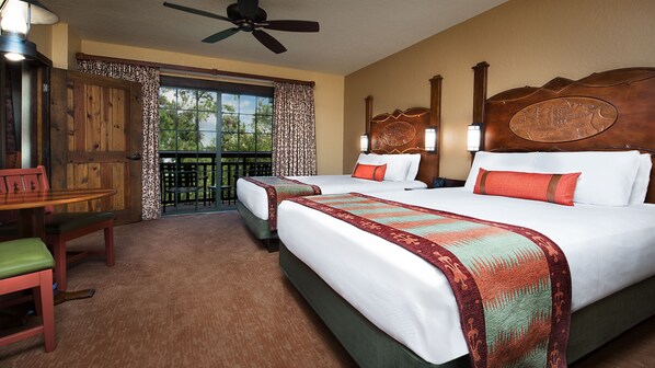 A hotel room with two beds, a balcony, a dining area, and a view of the outdoors.