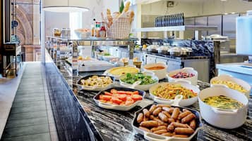 A buffet with various dishes and a marble countertop.