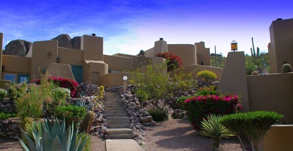 A desert-style building with stucco walls, a stone staircase, and various desert plants. - Gold Canyon Golf Resort & Spa (Gold Canyon)