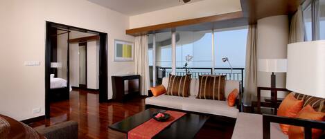 A modern living room with a sofa, coffee table, and a ceiling fan.