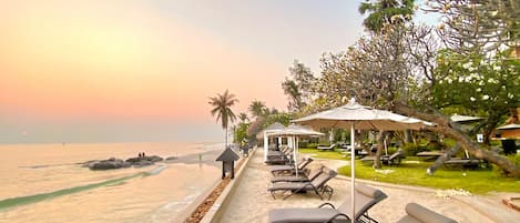 On the beach, sun-loungers, beach umbrellas, beach bar