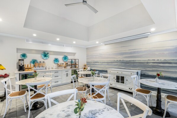 Enjoy meals in this stylish dining area with a high ceiling, round table, and comfortable seating.