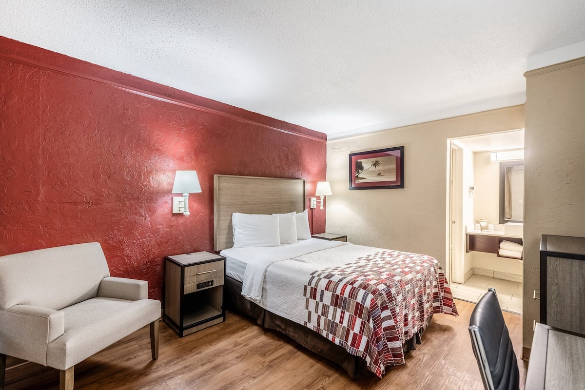Premium bedding, desk, laptop workspace, blackout drapes