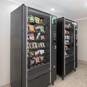 Two vending machines stocked with snacks and beverages. - Red Roof Inn Tampa Bay - St Petersburg (St. Petersburg)