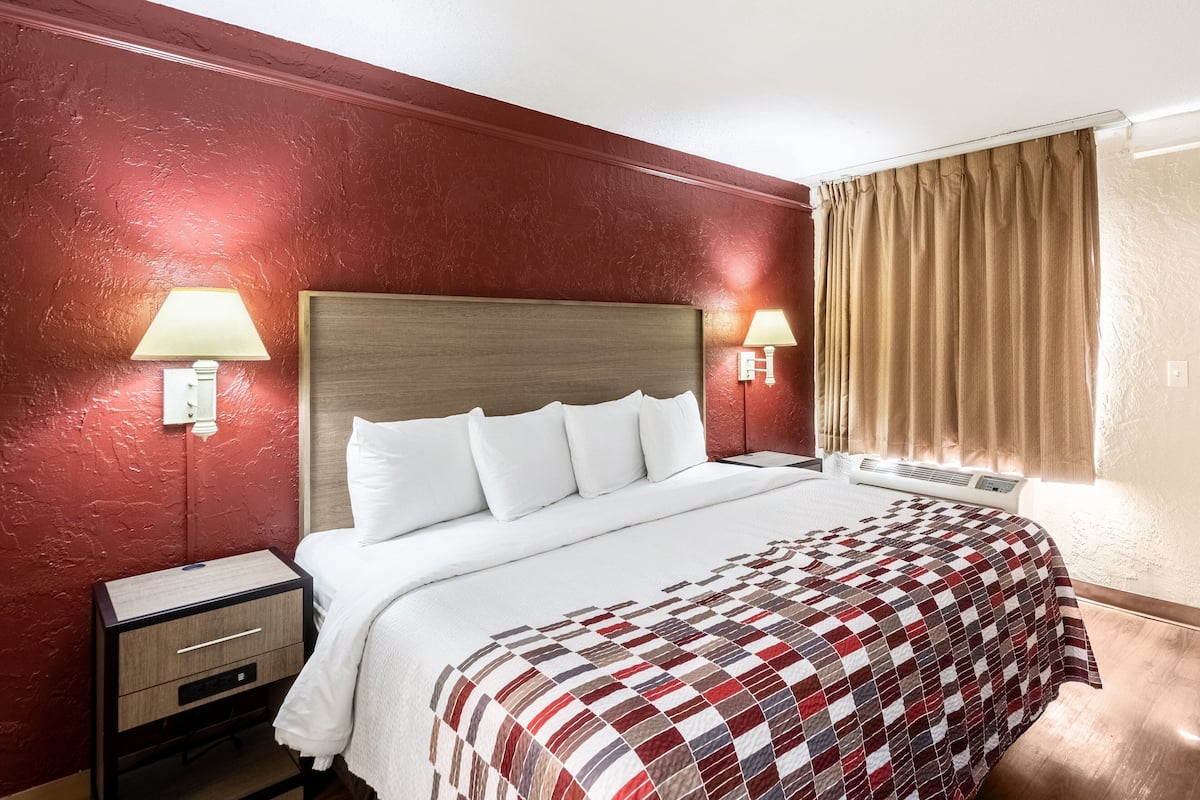 Premium bedding, desk, laptop workspace, blackout drapes