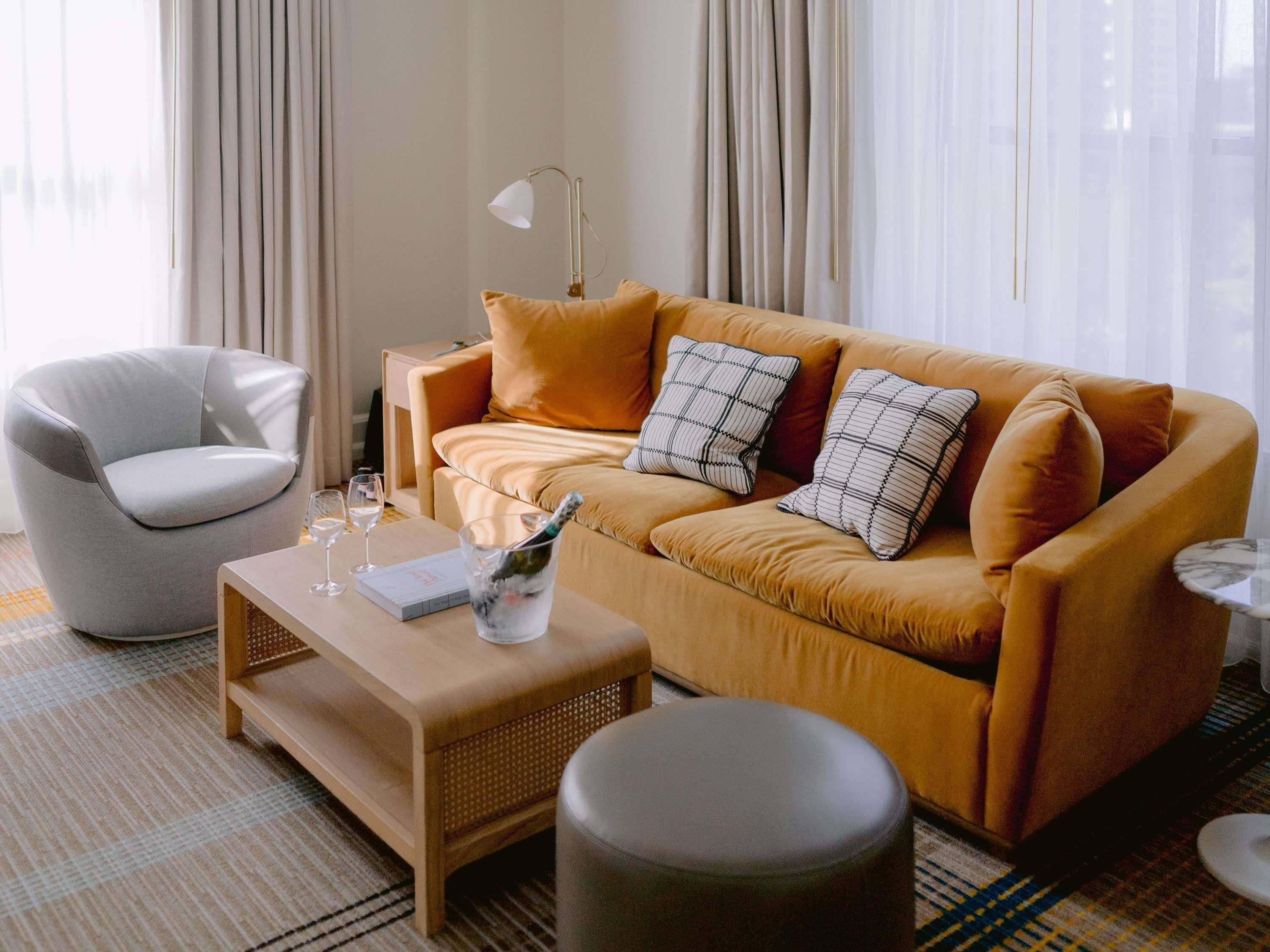 A modern living room with a sofa, armchair, and a small coffee table.