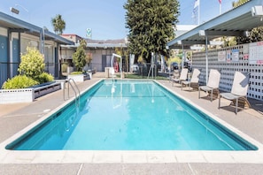 Outdoor pool, open 9 AM to 10 PM, pool loungers
