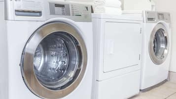 Two white LG commercial washers in a laundry room.