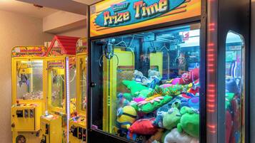 Una fila di macchinette arcade con peluche all'interno, con l'indicazione 'Prize Time'.