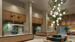A modern lobby with a reception desk, seating area, and a large plant with hanging lights. - Renaissance Orlando Resort – Disney Springs® Area (Lake Buena Vista)