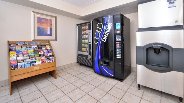 A vending area with a book display and two beverage machines. - Red Roof Inn Milwaukee – Airport/Oak Creek (Oak Creek)