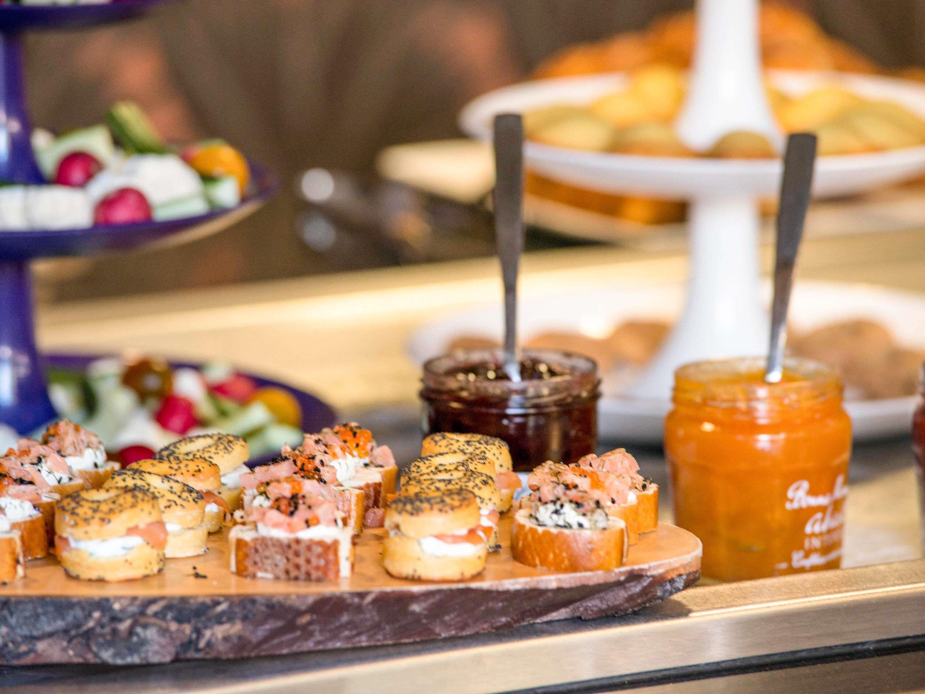 A buffet with various food items, including sandwiches and spreads.