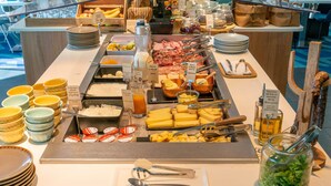 A buffet with various food items and condiments, including cheese, meats, and a salad. - Mercure Toulouse Centre Saint-Georges Hotel (Toulouse)