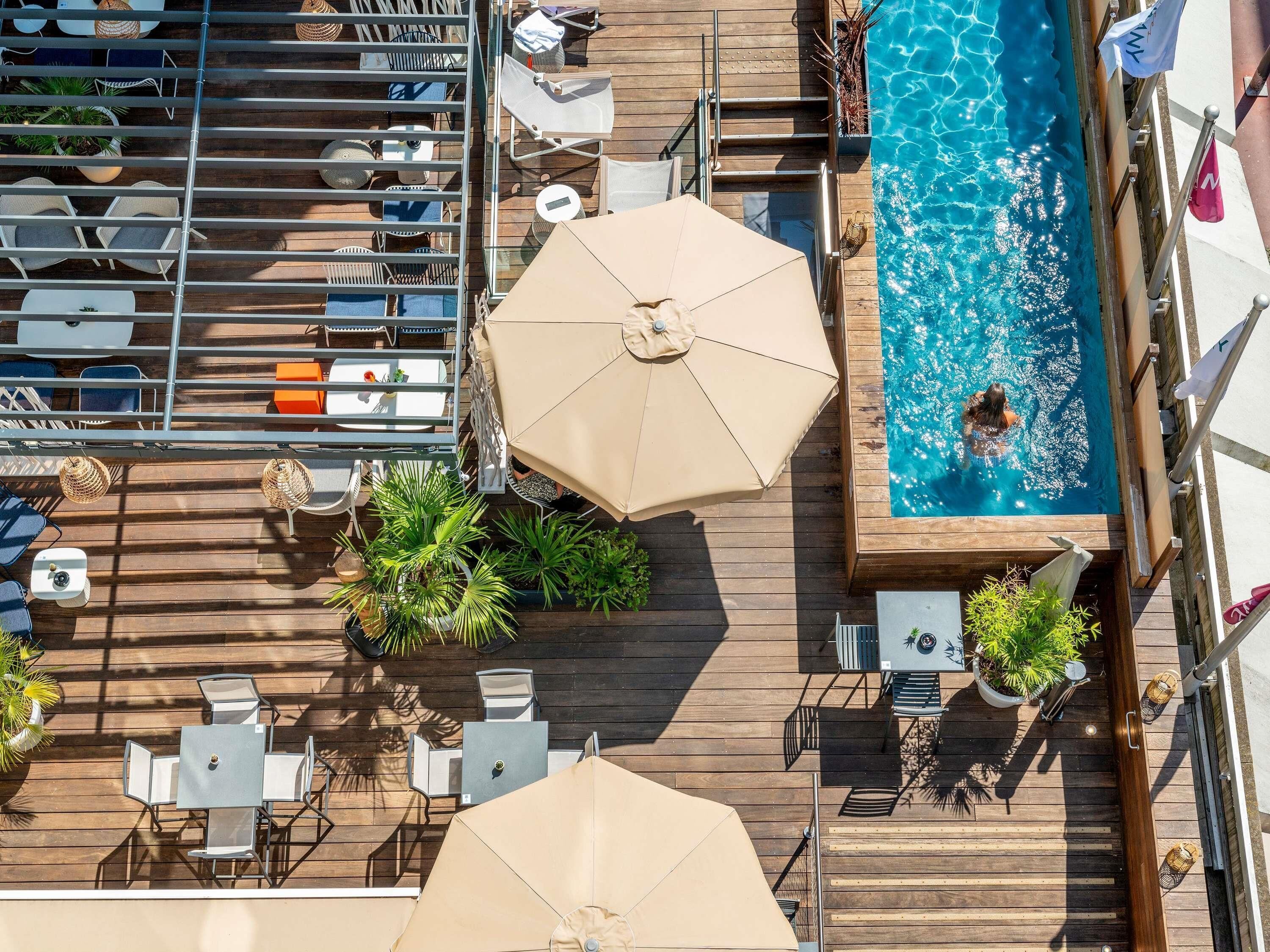 Seasonal outdoor pool, open 9:00 AM to 7:00 PM, pool umbrellas